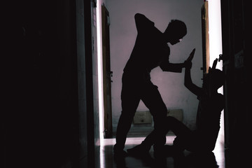 Silhouette young man being mugged in a dark alley at condo. Male robber. concept bandit in dark...