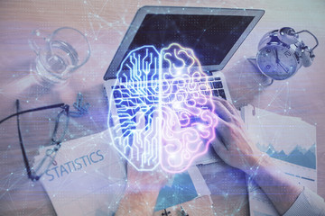 Man typing on keyboard background with brain hologram. Concept of big Data.