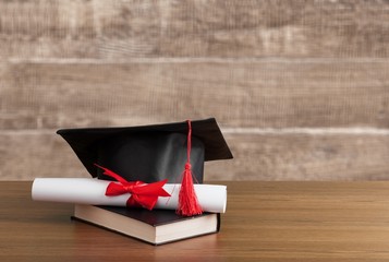 Graduate cap desk hat table academic achievement