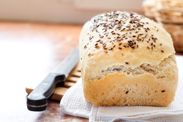 Homemade wheat bread with flax seeds on a kitchen table