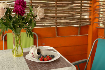 Summer arbor. The Utrenny light breakfast from berries. A honeysuckle with a wild strawberry and...