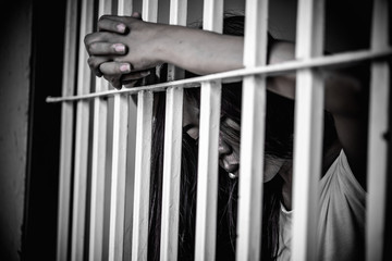 Obraz premium Hands of women desperate to catch the iron prison,prisoner concept,thailand people,Hope to be free,If the violate the law would be arrested and jailed.