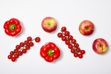 top view of red apples and vegetables on white background