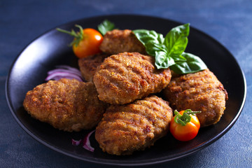 Delicious homemade burgers or patties and vegetables