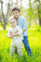 Two cute little boys playing outdoor in park.