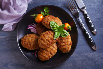 Delicious homemade burgers or patties and vegetables. View from above, top studio shot