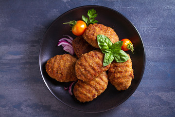Delicious homemade burgers or patties and vegetables. View from above, top studio shot