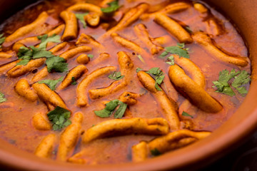 Dhaba style Sev bhaji/sabzi/curry made in tomato curry with gathiya shev, served in a bowl or karahi, selective focus