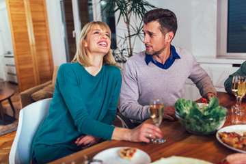 Happy family having meal in kitchen at home