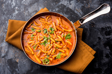 Dhaba style Sev bhaji/sabzi/curry made in tomato curry with gathiya shev, served in a bowl or karahi, selective focus