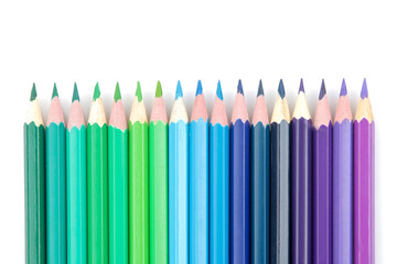 Many color pencils on white isolated background. close-up. stationery.