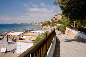 Fototapeta na wymiar Empty wooden fenced path leading to Cabo Roig beach, Spain