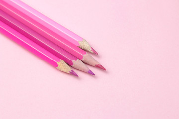 composition with pink pencil on a bright trendy pink background. top view. space for text