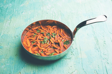 Dhaba style Sev bhaji/sabzi/curry made in tomato curry with gathiya shev, served in a bowl or karahi, selective focus