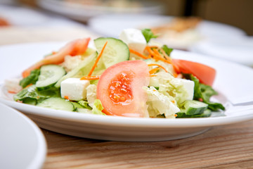 greek salad on the wooden background