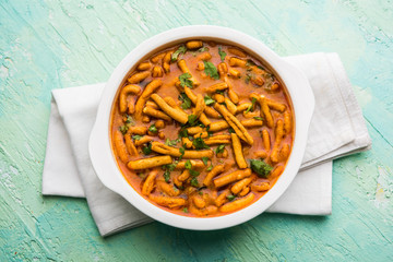 Dhaba style Sev bhaji/sabzi/curry made in tomato curry with gathiya shev, served in a bowl or karahi, selective focus