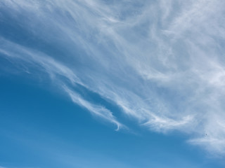 Blue sky with white clouds close up in the summertime