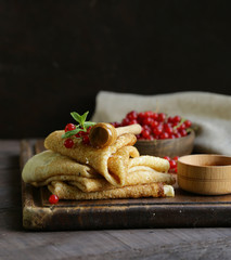 thin pancakes with berries and honey