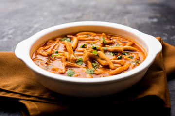 Dhaba style Sev bhaji/sabzi/curry made in tomato curry with gathiya shev, served in a bowl or karahi, selective focus