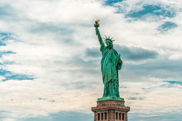 Obraz premium New York City Statue Of Liberty Against Cloudy Blue Sky Background, Copy Space