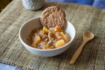 apple compote with cinnamon, seeds and an oat cookie