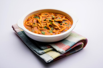 Dhaba style Sev bhaji/sabzi/curry made in tomato curry with gathiya shev, served in a bowl or karahi, selective focus