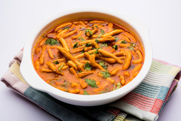 Dhaba style Sev bhaji/sabzi/curry made in tomato curry with gathiya shev, served in a bowl or karahi, selective focus