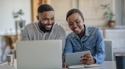 Smiling African American couple working on their household finances together