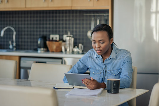 Young African American woman using a digital tablet at home