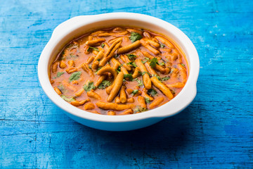 Dhaba style Sev bhaji/sabzi/curry made in tomato curry with gathiya shev, served in a bowl or karahi, selective focus