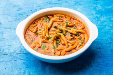 Dhaba style Sev bhaji/sabzi/curry made in tomato curry with gathiya shev, served in a bowl or karahi, selective focus