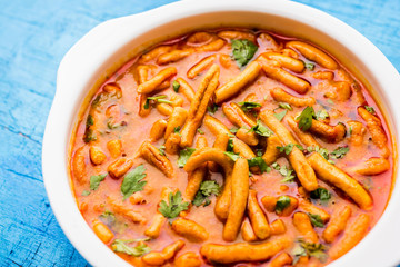 Dhaba style Sev bhaji/sabzi/curry made in tomato curry with gathiya shev, served in a bowl or karahi, selective focus