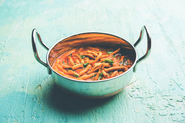 Dhaba style Sev bhaji/sabzi/curry made in tomato curry with gathiya shev, served in a bowl or karahi, selective focus