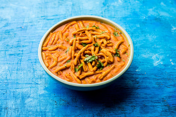 Dhaba style Sev bhaji/sabzi/curry made in tomato curry with gathiya shev, served in a bowl or karahi, selective focus