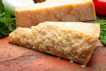 Italian original aged Parmesan cheese in two pieces close up