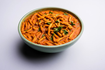 Dhaba style Sev bhaji/sabzi/curry made in tomato curry with gathiya shev, served in a bowl or karahi, selective focus