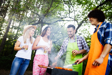 Group of friends having a barbecue party in nature