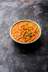 Dhaba style Sev bhaji/sabzi/curry made in tomato curry with gathiya shev, served in a bowl or karahi, selective focus