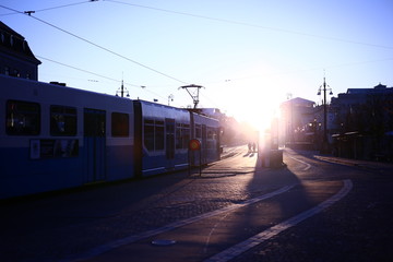 Early winter morning on a tram stop with strong sunlight on the Avenue, Gothenburg, Sweden