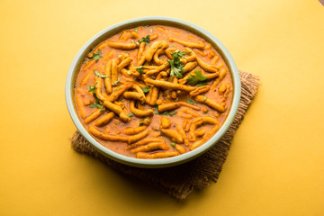 Dhaba style Sev bhaji/sabzi/curry made in tomato curry with gathiya shev, served in a bowl or karahi, selective focus