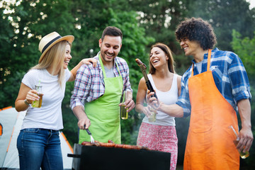 Group of friends having a barbecue party in nature