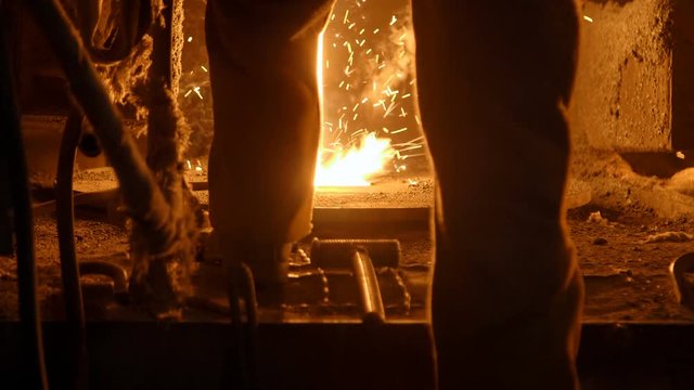 Metallurgist at work by the blast furnance, iron and steel works