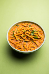 Dhaba style Sev bhaji/sabzi/curry made in tomato curry with gathiya shev, served in a bowl or karahi, selective focus