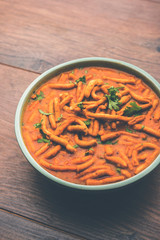 Dhaba style Sev bhaji/sabzi/curry made in tomato curry with gathiya shev, served in a bowl or karahi, selective focus
