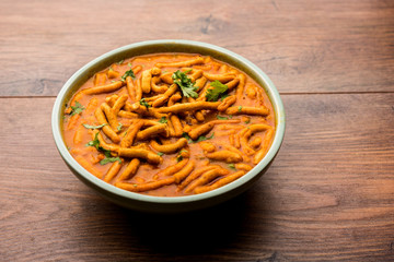 Dhaba style Sev bhaji/sabzi/curry made in tomato curry with gathiya shev, served in a bowl or karahi, selective focus