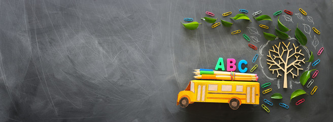 education and back to school concept. Top view photo of school bus and ABC letters, pencils on the...