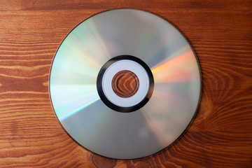 CD compact disc  on a light wooden background top view 