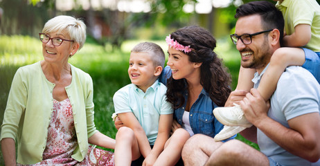 Happy family enjoying picnic in nature at summer