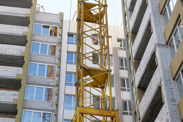 Building and Construction site of new home. Facade of many story new house under construction. House under construction at building site.