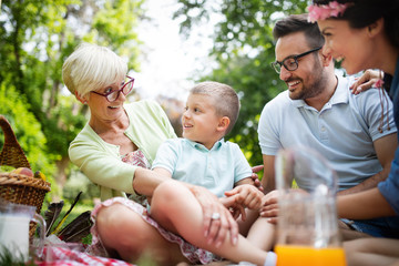 Happy family enjoying picnic in nature at summer